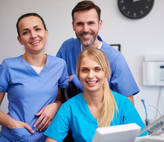 Three happy, smiling dental team members