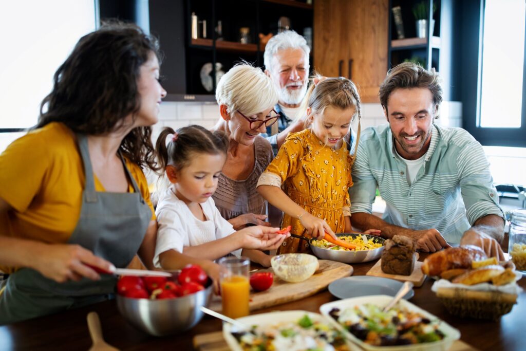 3 generations of a family making dinner together in the kitchen